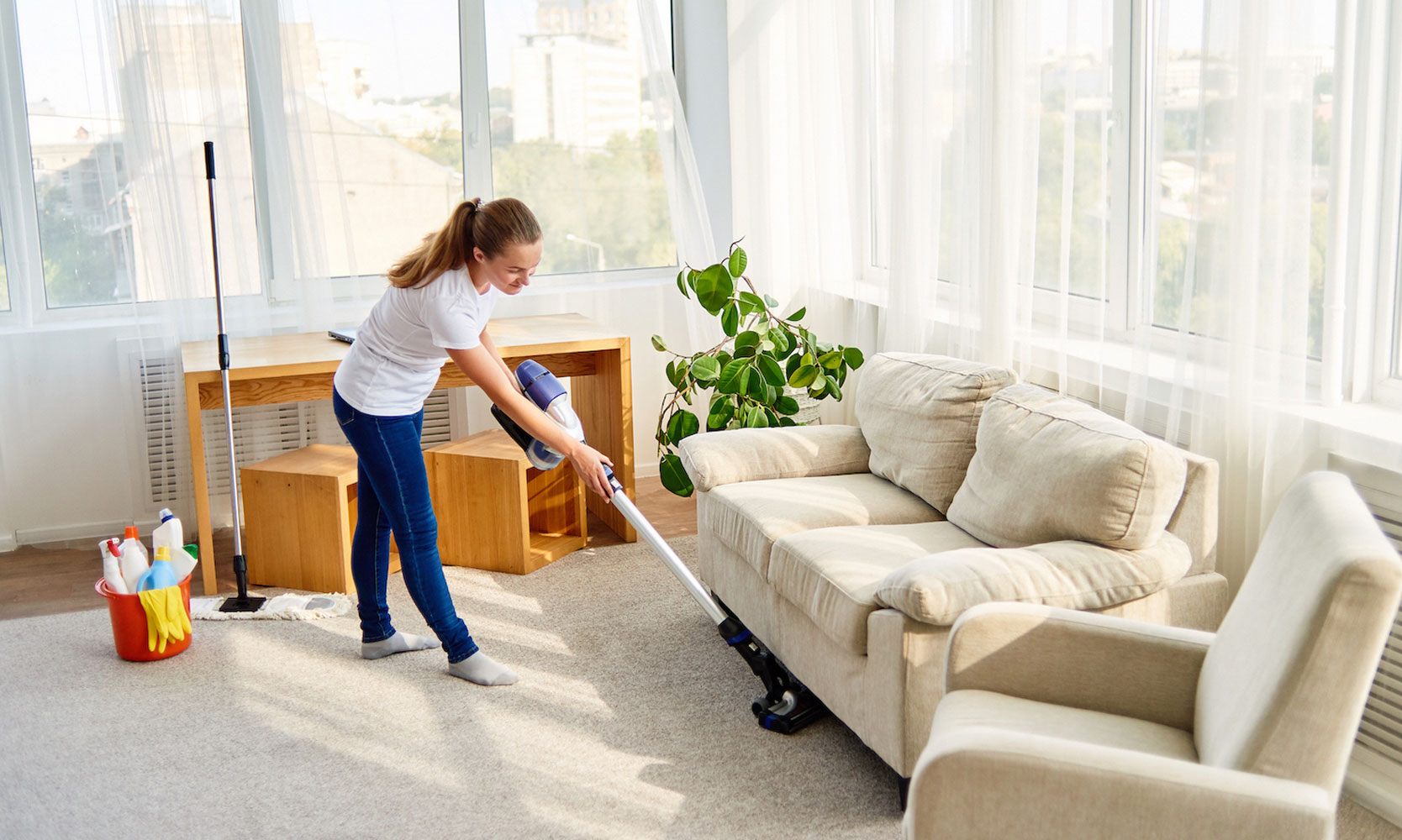 A ccleaner vacuuming a clean and organized space with cleaning supplies and tools, showcasing the importance of cleanliness and tidiness.