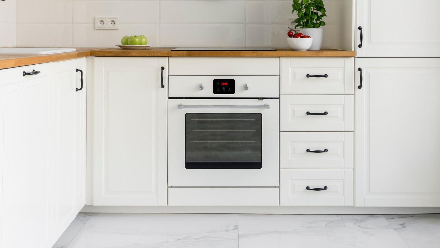 A picture of a white oven in a bright and clean kitchen.