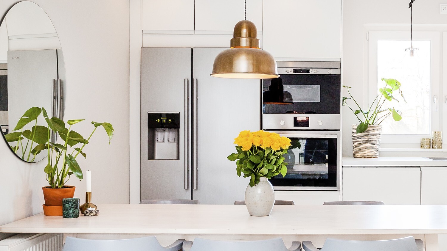 A modern kitchen with a 2-door fridge and an oven.