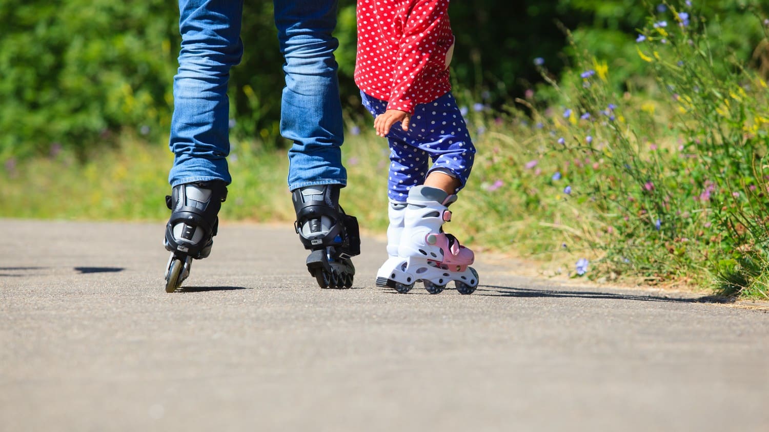 Persons wearing roller skates gliding gracefully on a smooth surface.