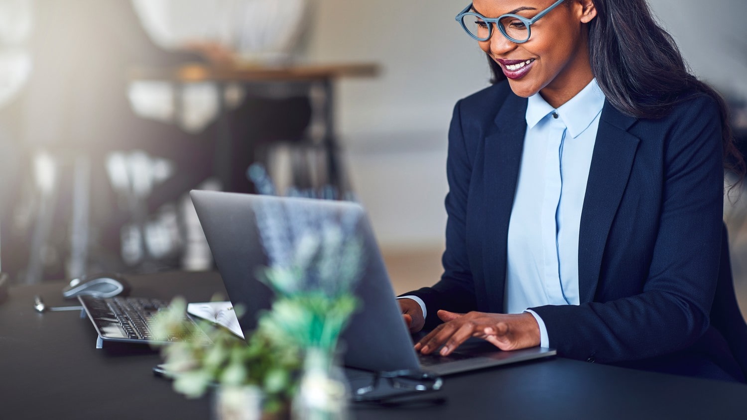 A close-up of a lawyer typing a legal document on her laptop.