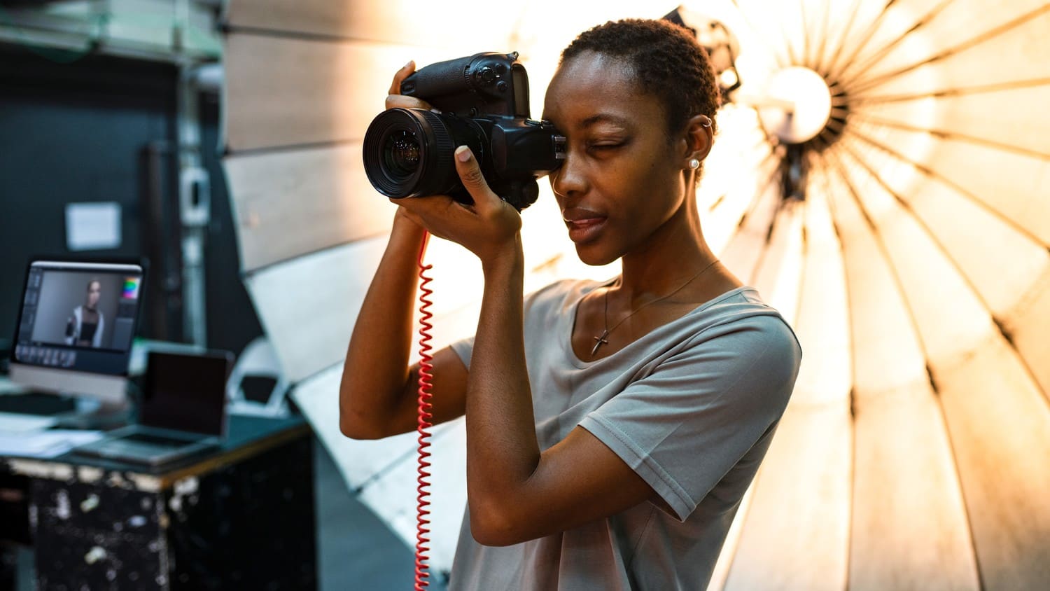 A professional portrait photographer capturing a stunning image of a person, with a blurred background and perfect lighting.