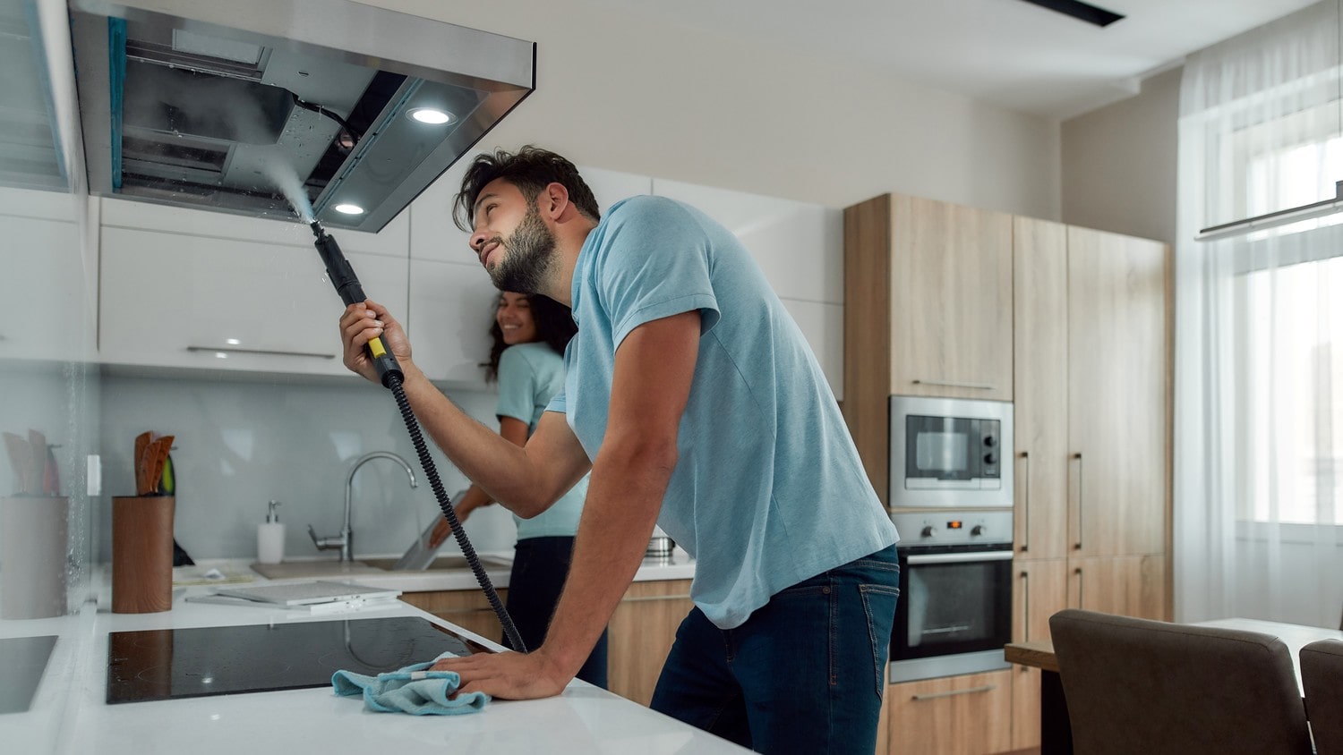 A close-up of a rangehood being cleaned.