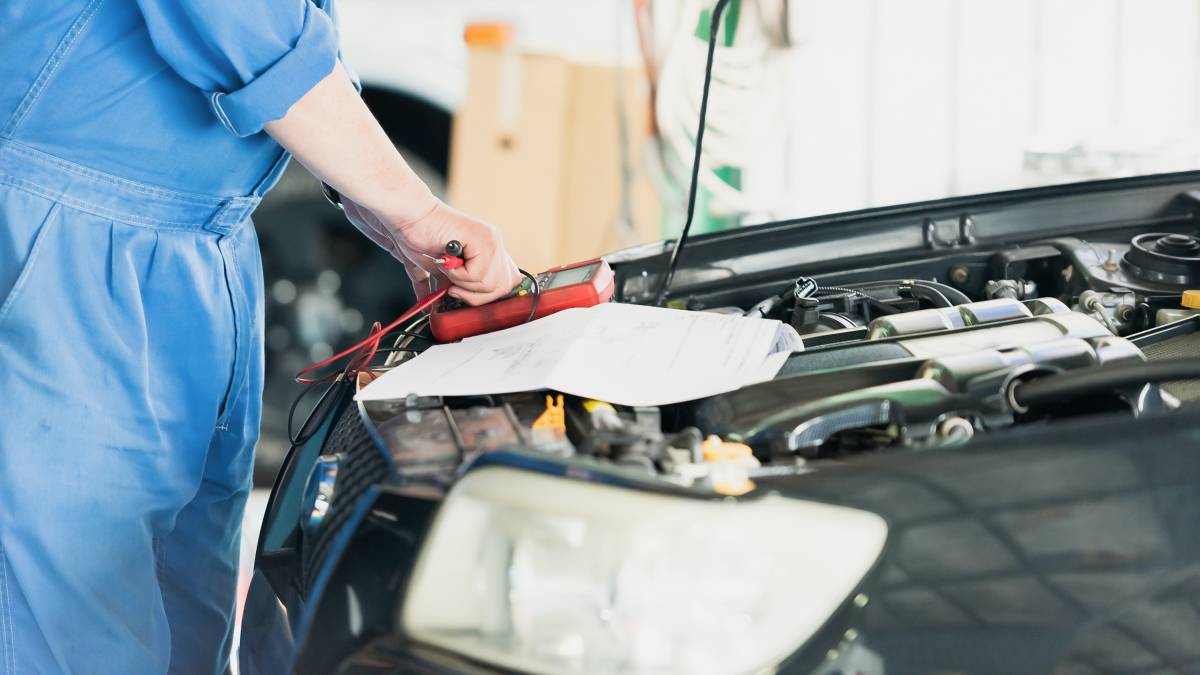 ford car service mechanic checking car battery