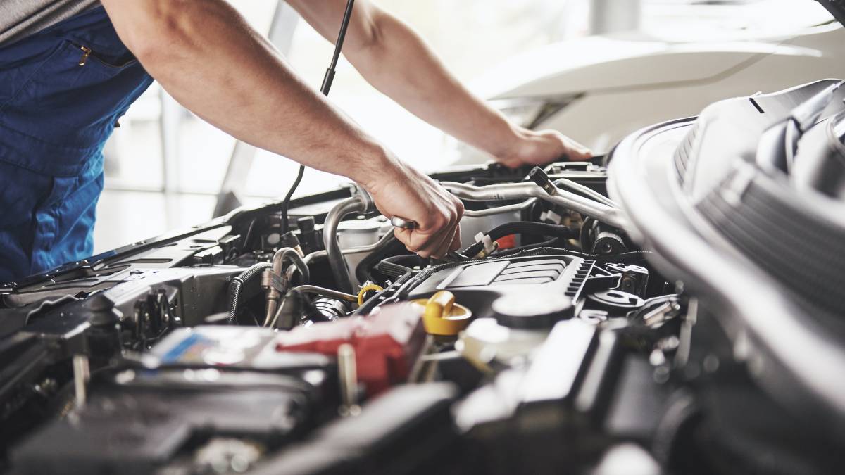 mechanic inspecting a mazda car for service