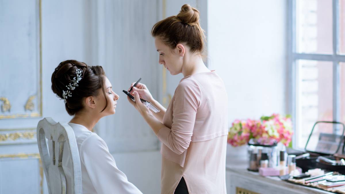 bridal makeup artist with the bride