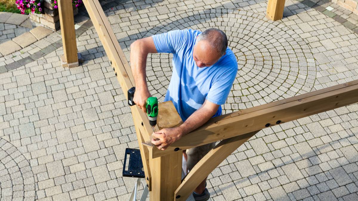 a man building a pergola