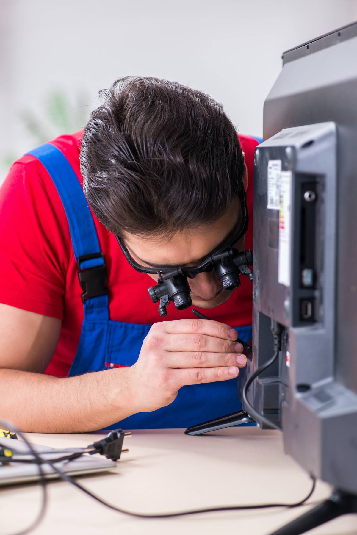 a handyman repairing a TV