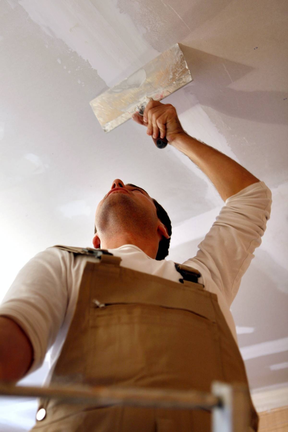 Man plastering ceiling