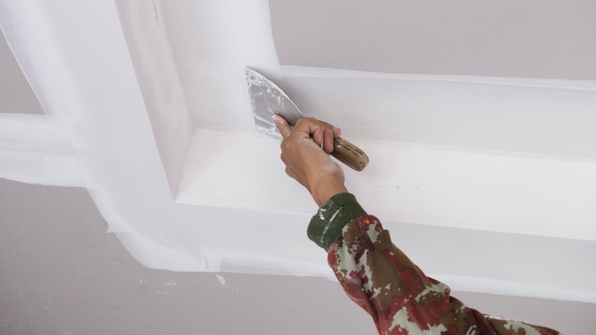 man plastering ceiling