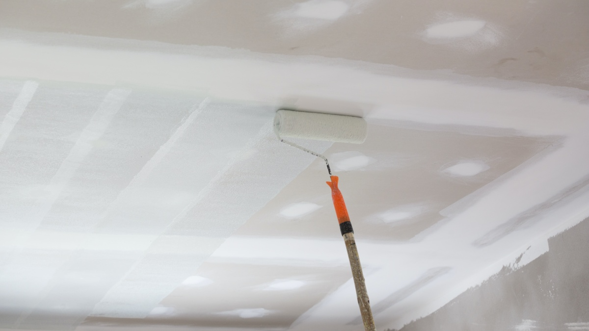 using a roller to paint ceiling