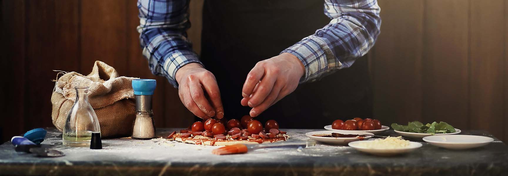 A private chef preparing a delicious meal in a modern kitchen, surrounded by fresh ingredients and cooking utensils.