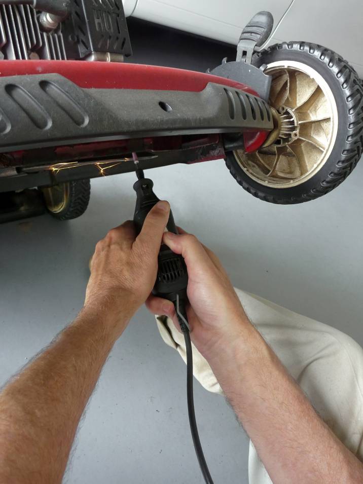 a man sharpening a lawnmower blade