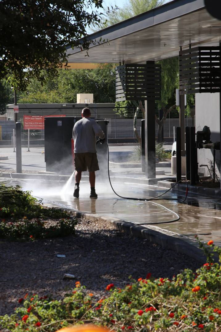 a man cleaning a driveway