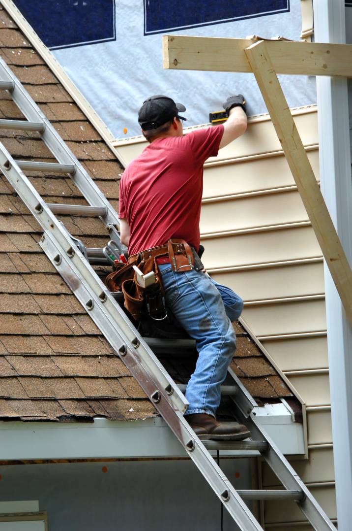 a handyman installing siding