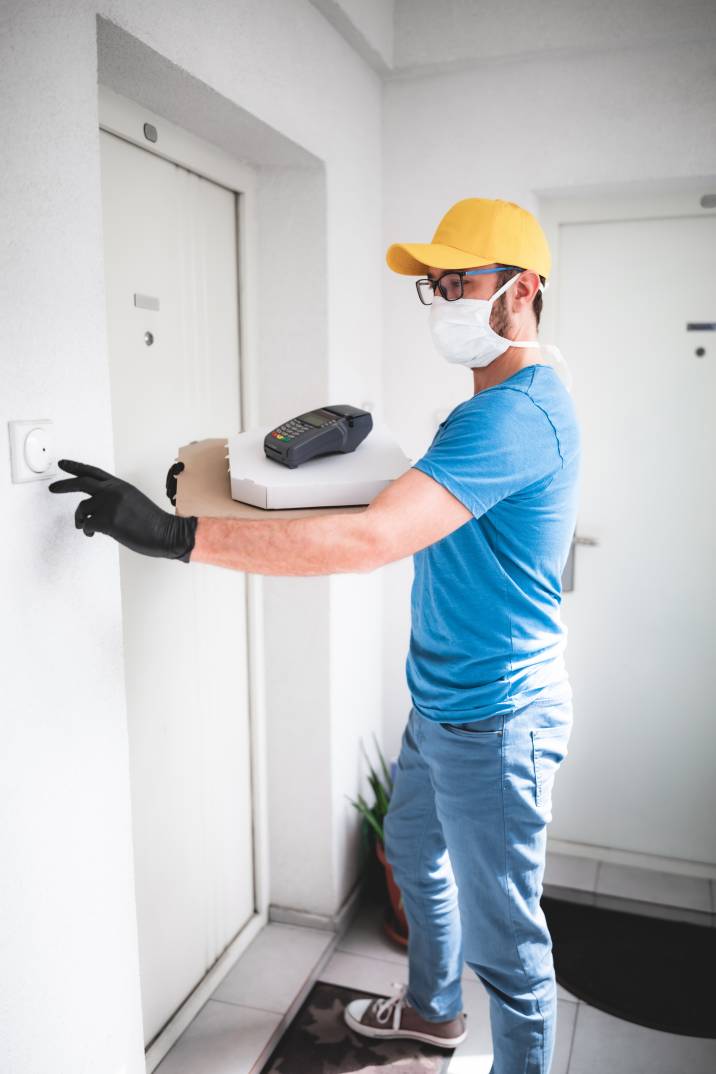 a delivery guy ringing a residential doorbell