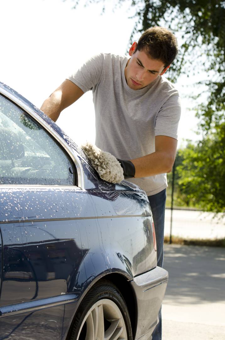 Premium Photo  Man cleans auto with car rim cleaner, carwash. carwashing  station