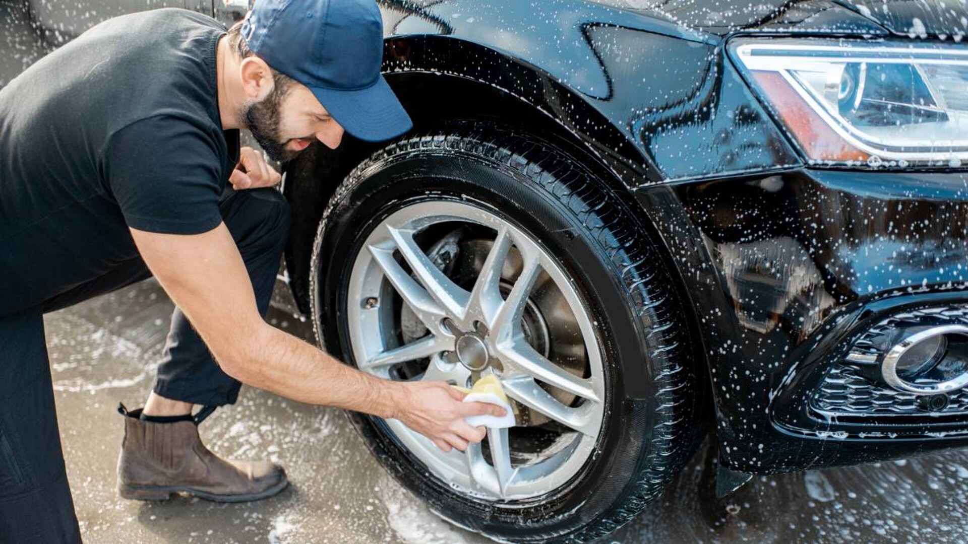 Premium Photo  Man cleans auto with car rim cleaner, carwash. carwashing  station
