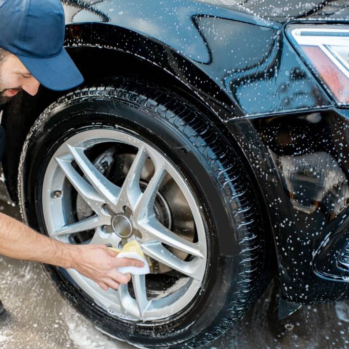 Premium Photo  Man cleans auto with car rim cleaner, carwash. carwashing  station