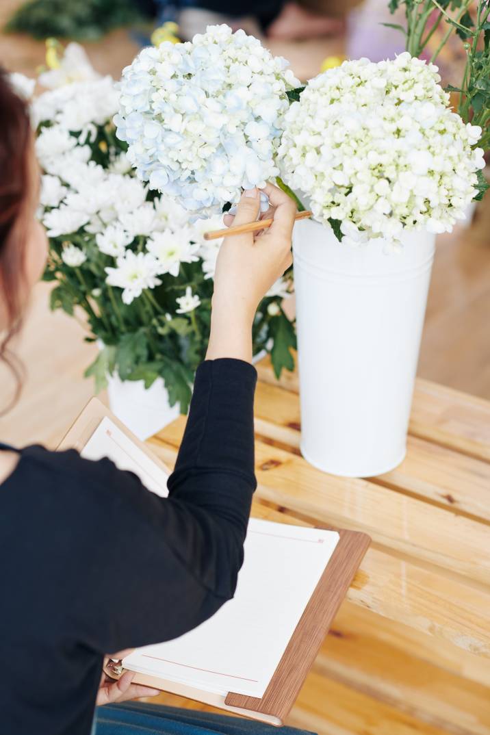 a wedding planner selecting floral arrangements