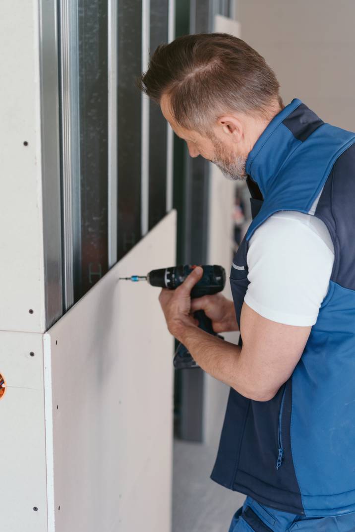 a handyman cladding a residential wall