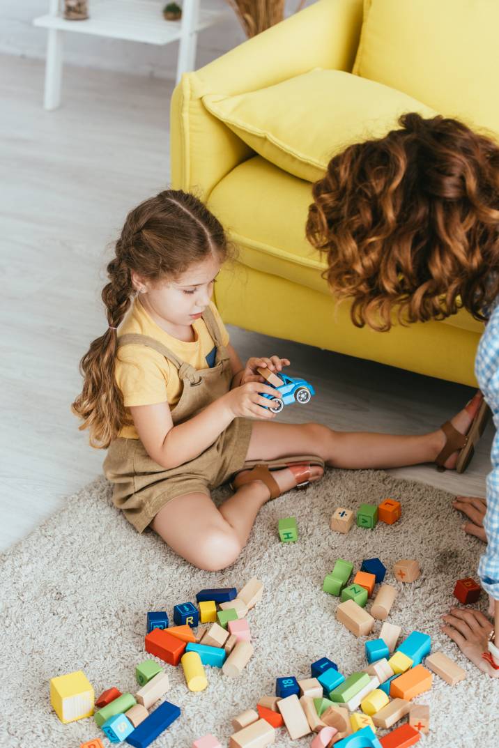 a nanny playing with a little girl