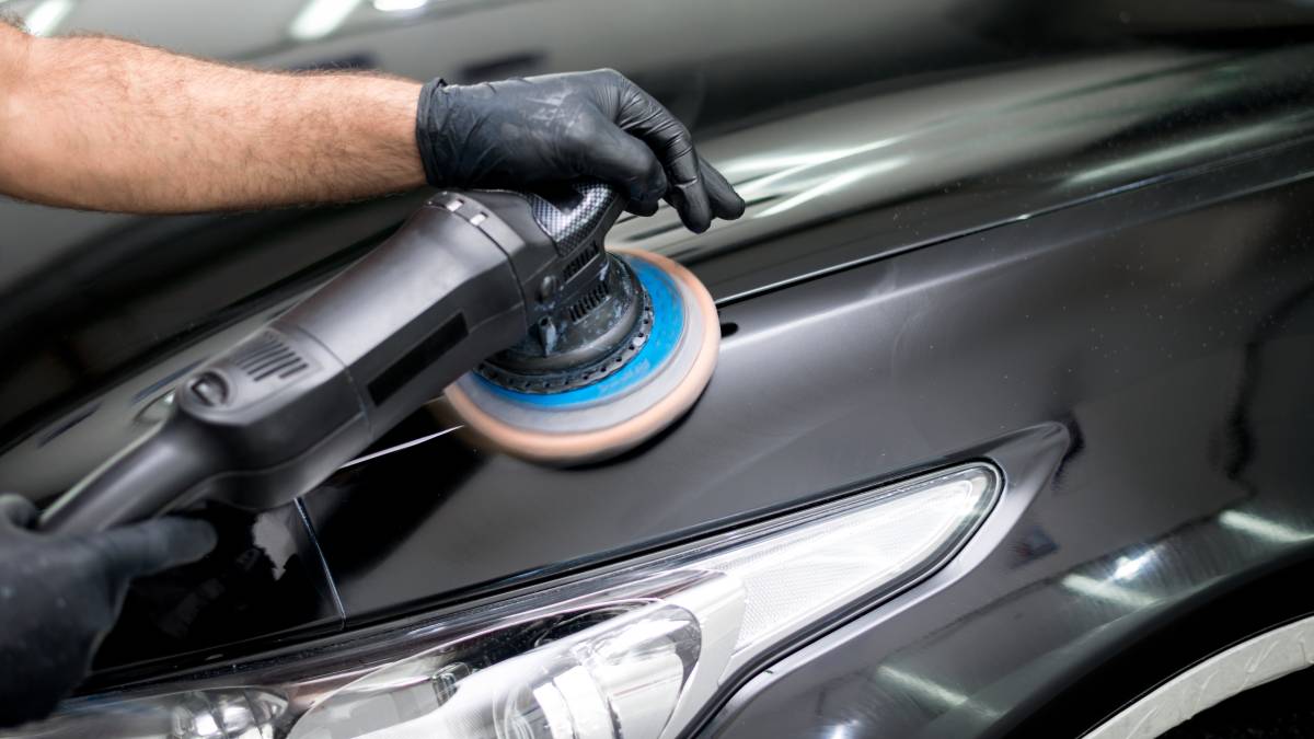 car detailer polishing vehicle hood