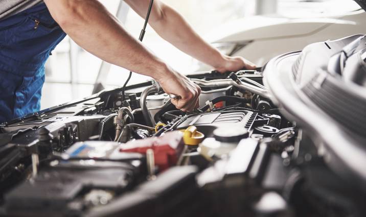 car mechanic repairing a flood damaged car