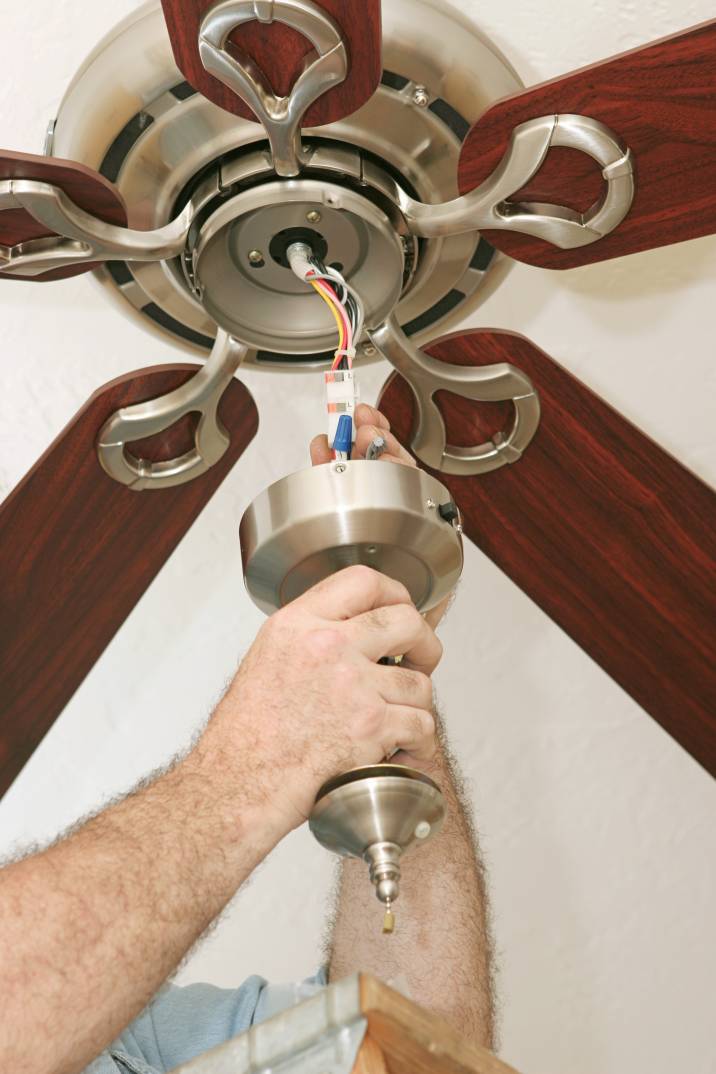 a handyman installing a ceiling fan