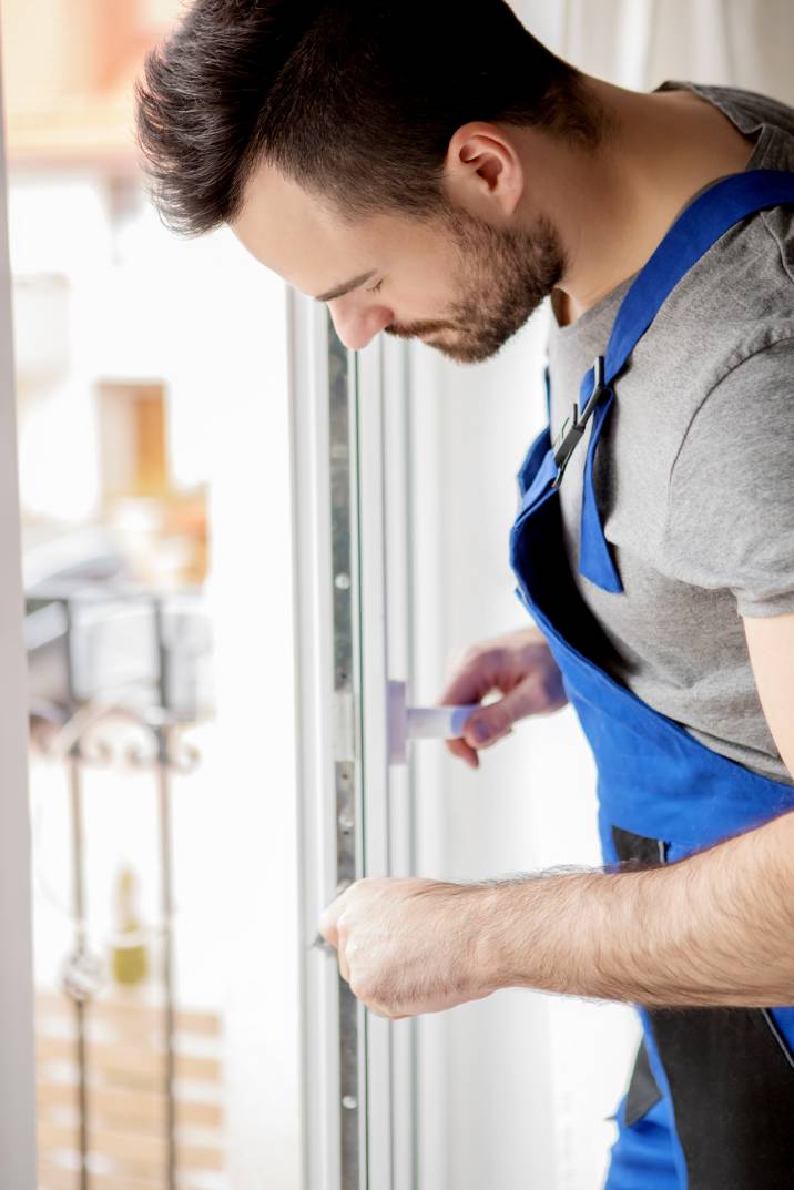 a handyman repairing a window