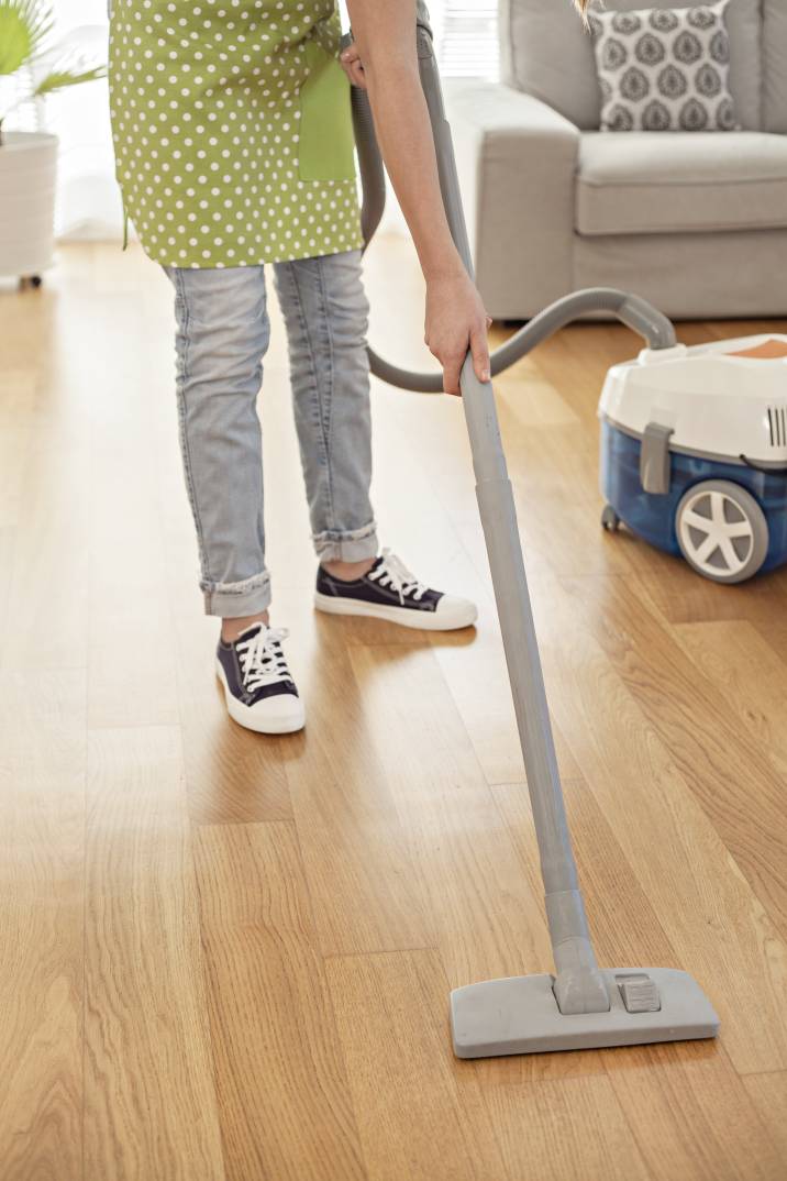 a woman vacuuming the floor of a home