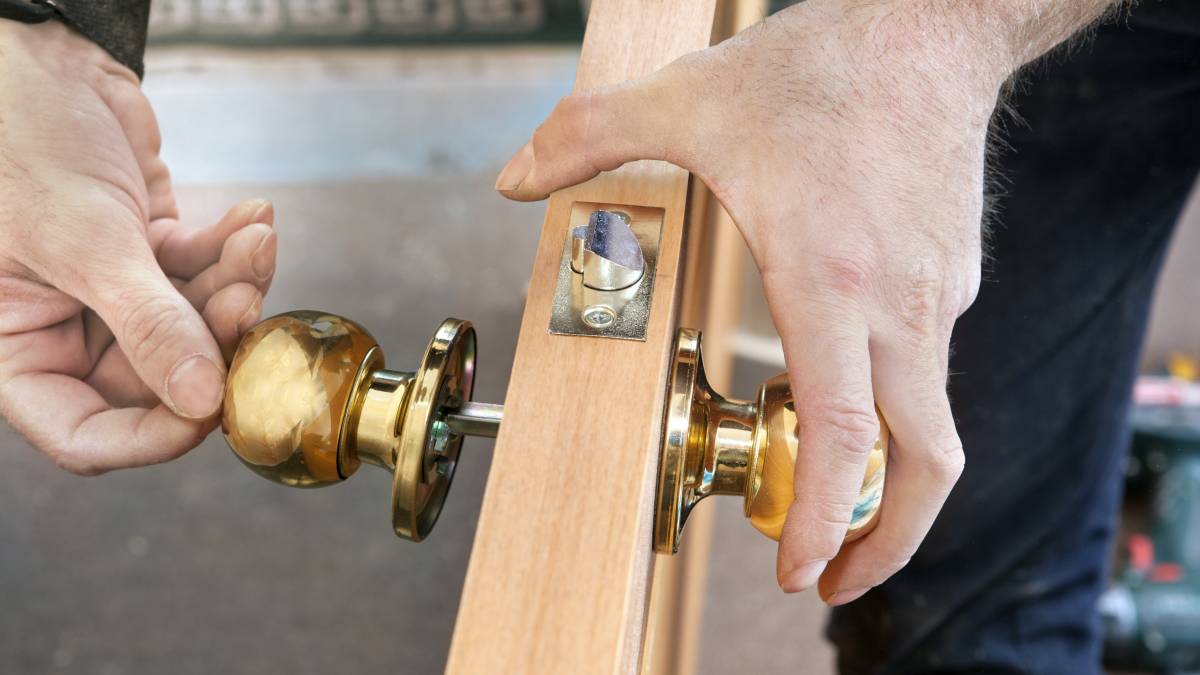 handyman installing a door knob
