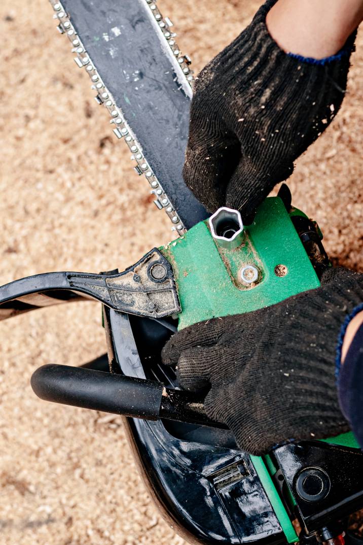 a handyman tuning up a chainsaw