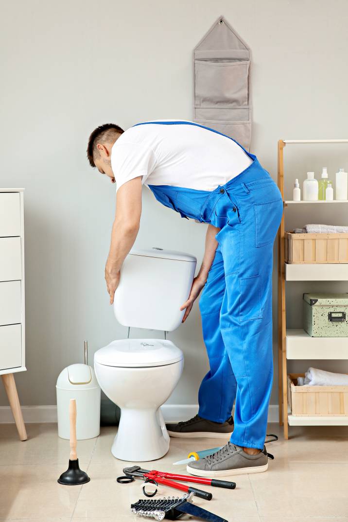 a plumber assembling a new toilet