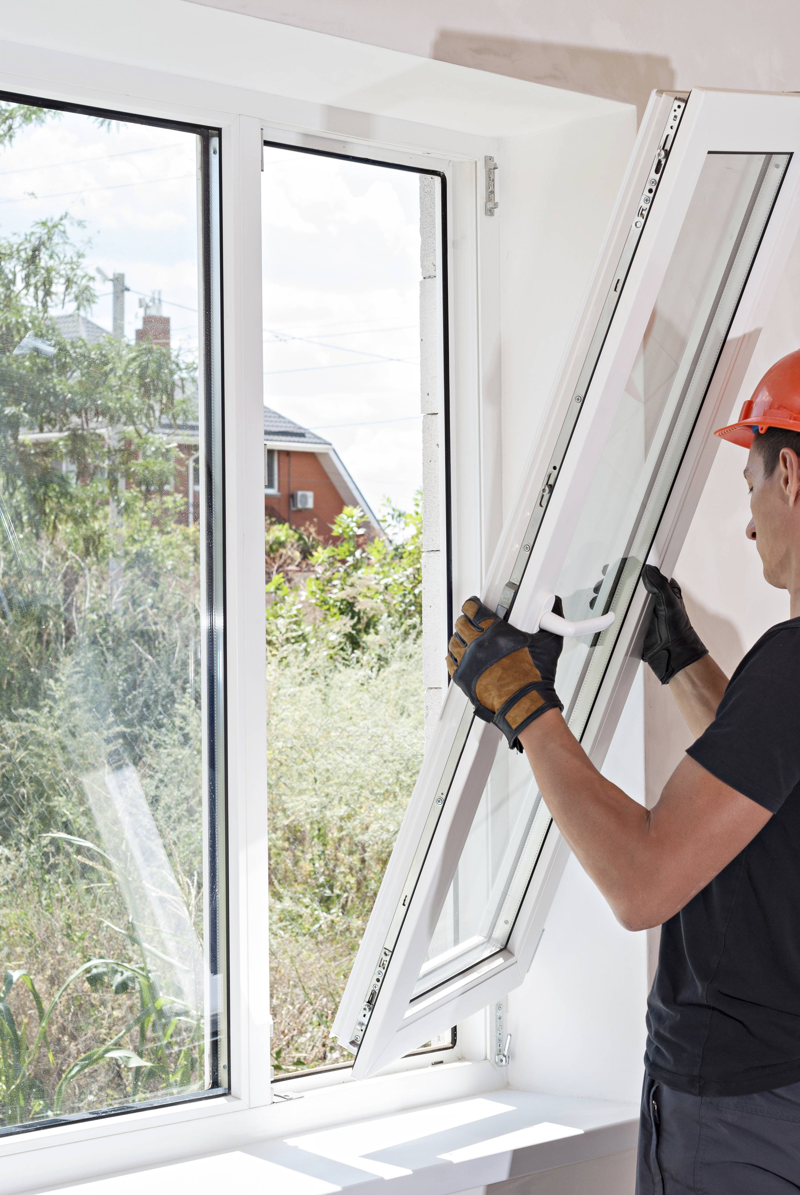 a handyman installing a new window