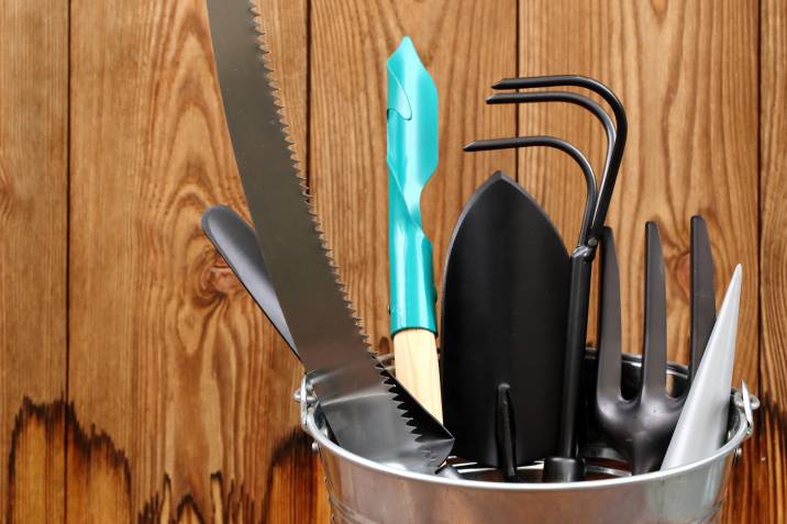 Clean garden tools stored in a metal bucket