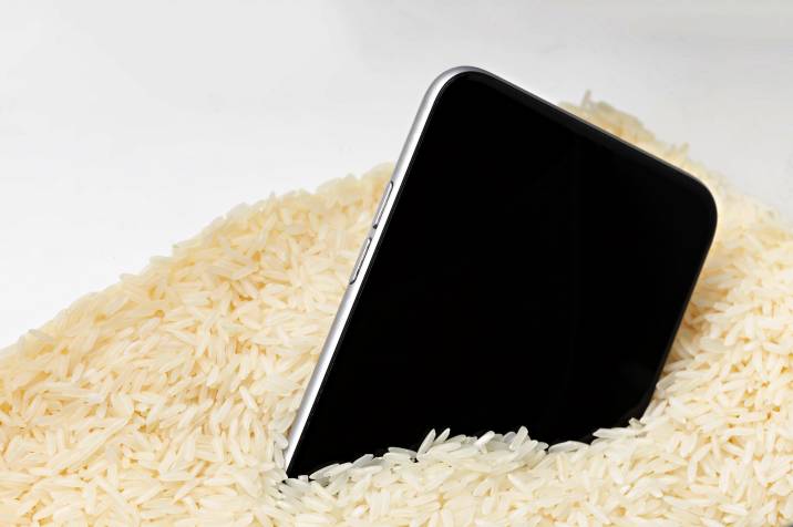a smartphone drying in a container of rice