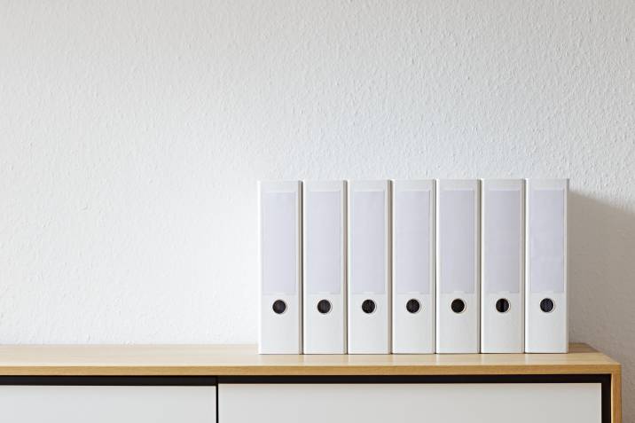 several file folders on a shelf