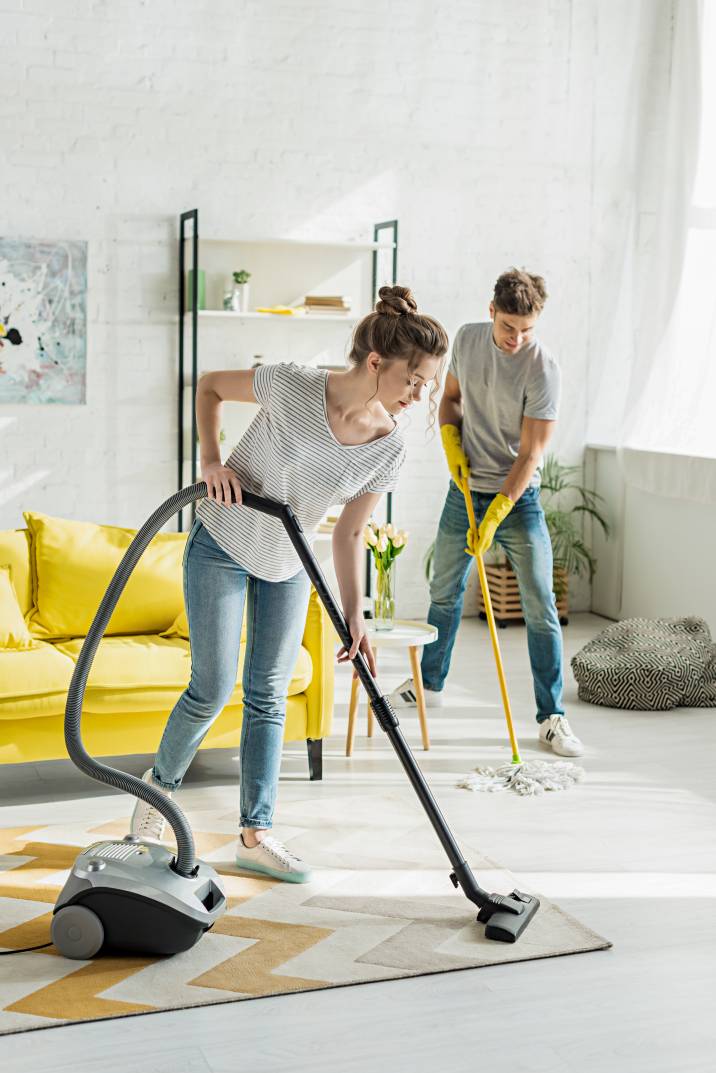 two people cleaning a floor