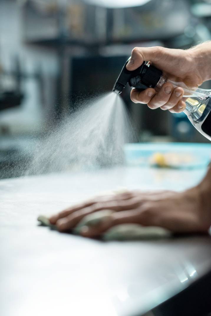 a man cleaning a commercial kitchen counter