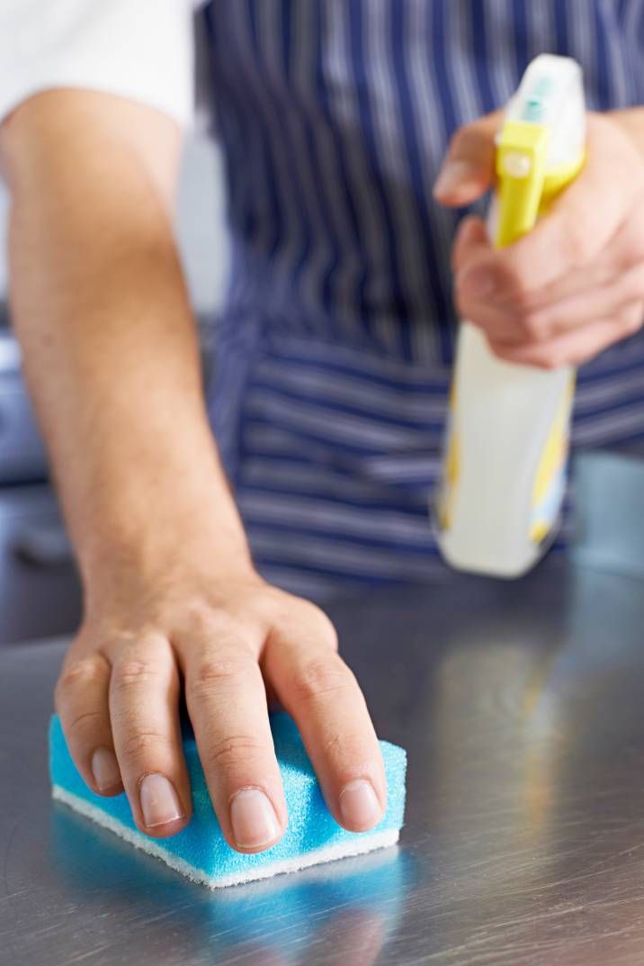 a man cleaning a commercial kitchen