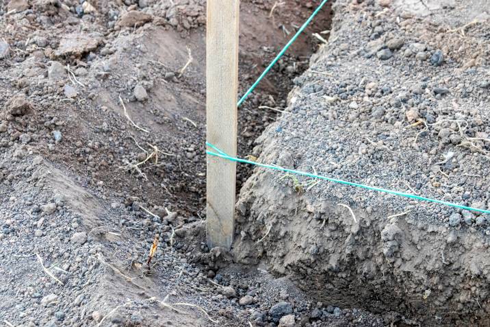 Marking peg with a stretched rope for garden steps under construction