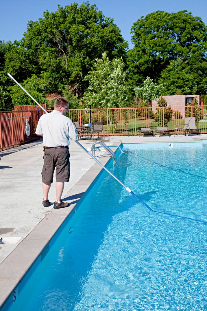 a man cleaning a pool