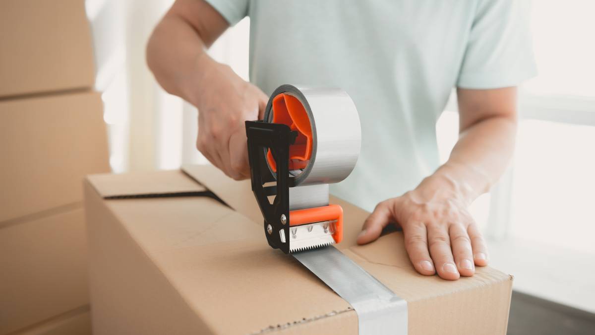 Person packing items into boxes for storage