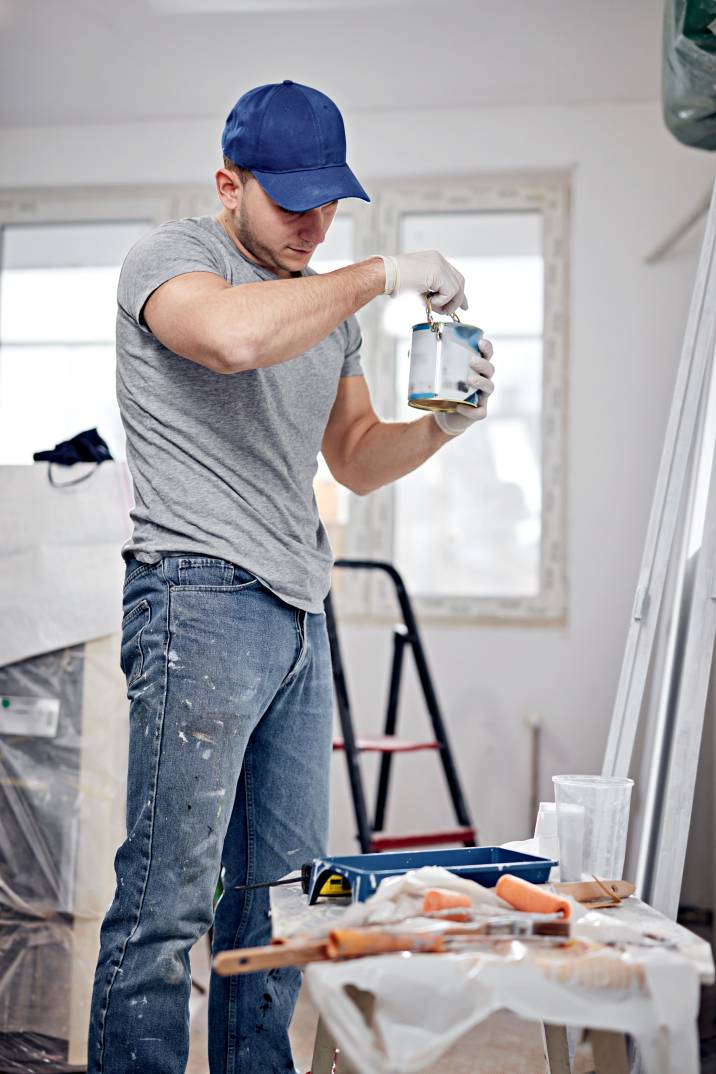 a man holding a can of paint