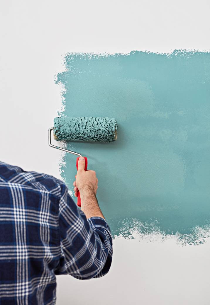 a man painting a white wall