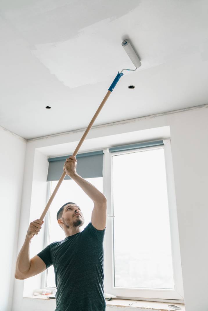 a man painting the ceiling