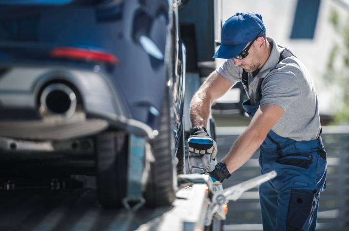 a man preparing to transport a car