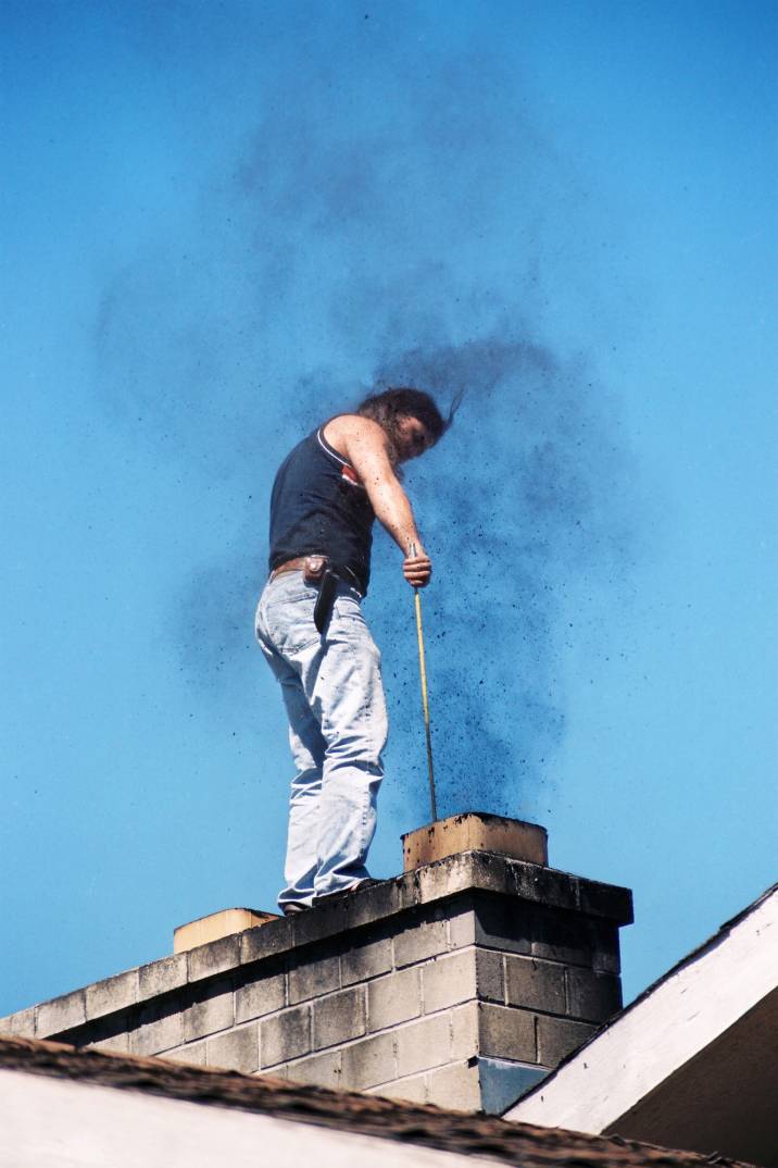 a man sweeping a chimney