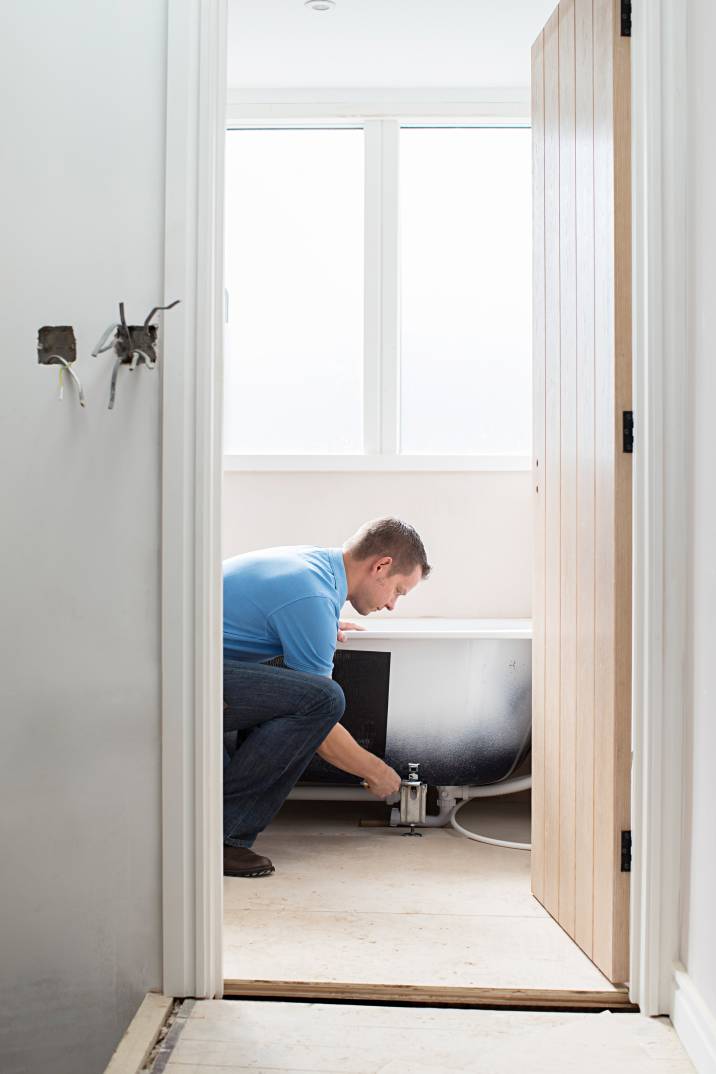 a handyman installing a bathtub